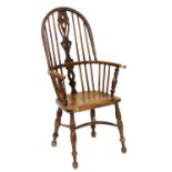 A 19thC oak and elm Windsor chair, with hoop back, pierced vase splat, solid saddle seat, raised on