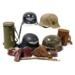 Two German M40 steel helmets and two others, a canteen with webbing case, and various leather items,