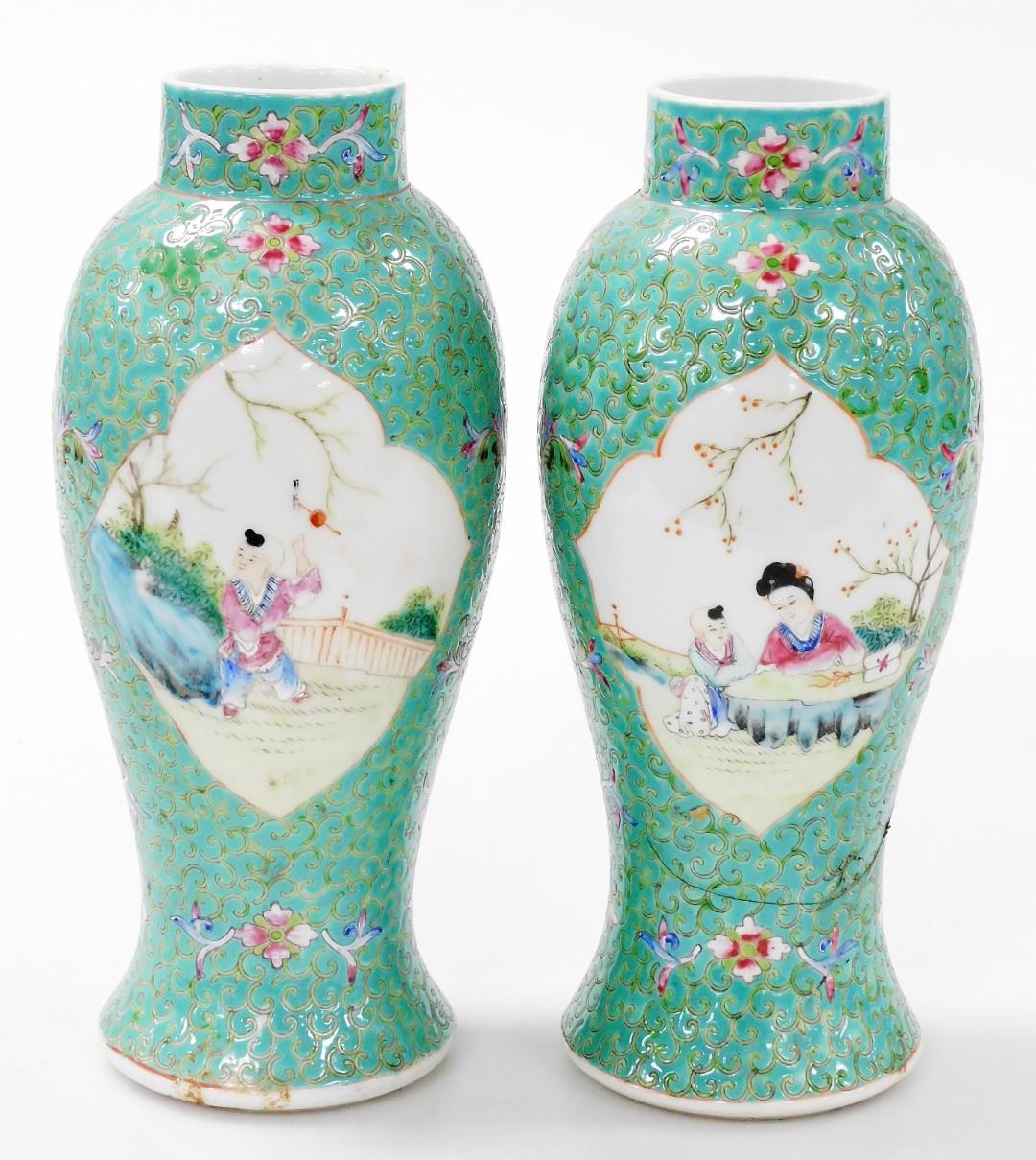 A pair of Chinese Republic famille rose porcelain vases, of baluster form, decorated with reserves o