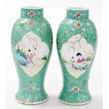 A pair of Chinese Republic famille rose porcelain vases, of baluster form, decorated with reserves o