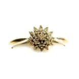 A platinum and diamond flower head ring, of three tier form, in a basket mount, set with nineteen ti