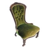 A Victorian mahogany spoon back nursing chair, upholstered in button back green draylon, raised on t