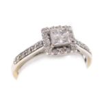 A diamond ring, set with four swept square cut diamonds, in a surround of sixteen round brilliant cu