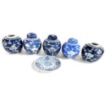 Five Qing Dynasty blue and white ginger jars, three with covers, decorated with prunus blossom again