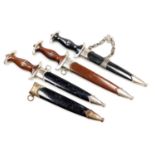 Three reproduction German daggers and one sheath.