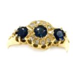 A 18ct gold three stone sapphire and diamond ring, in a claw mount, size N, Chester 1912, 2.19g.