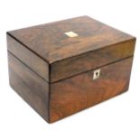 A Victorian rosewood work box, with mother of pearl escutcheons, the hinged lid opening to reveal a