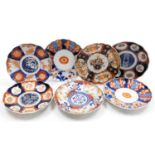 Seven Meiji period Japanese Imari porcelain plates, each of scalloped form, variously decorated, som