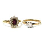 A 9ct gold and amethyst ring, the oval cut stone in a surround of cubic zirconia, in a high claw set