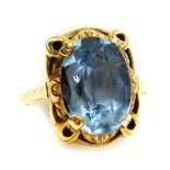 A 14ct gold and aquamarine ring, the oval cut aquamarine in a claw and foliate scroll mount, approx