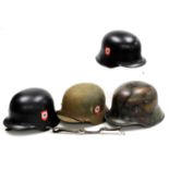 Three German steel M40 helmets, and one earlier. (4)
