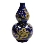 A 20thC Chinese porcelain vase, of double gourd form, decorated with five claw dragons on a blue gro