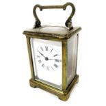 An early 20thC brass cased carriage clock, rectangular enamel dial bearing Roman numerals, single ba
