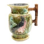 A late 19thC Continental Majolica jug, with a bamboo style handle, moulded with birds and oak branch