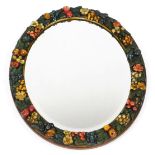 An early 20thC barbola type oval wall mirror, inset bevelled glass, the frame moulded with fruit and