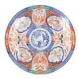 A large Meiji period Japanese Imari charger, decorated with reserves of rabbits, dragons, and birds,