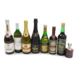 A group of alcohol, including a bottle of Napoleon VSOP brandy, Grant's Morello Cherry Brandy, Freix