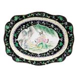 A Chinese Canton enamel dish, in 'famille noire' palette, the central reserve painted with a female