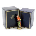 A Halcyon Days porcelain and silver gilt mounted scent bottle, modelled as a Scarlet Macaw, 10cm hig