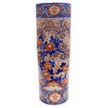 A Meiji period Imari cylindrical umbrella and stick stand, decorated in traditional blue and iron re