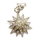 A Belle Epoque diamond starburst brooch, set with rose and old cut diamonds, in a twelve point white