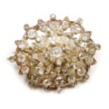 An Edwardian oval diamond floral brooch, in a yellow metal open work mount, set with brilliant cut d