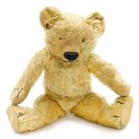 An early 20thC vintage Teddy bear, with a humped back, centre stitched body, jointed arms, legs and