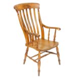 A Victorian oak and elm lath back kitchen chair, raised on turned legs united by a double H frame st