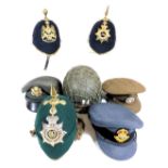 Three British Army helmets, with three regimental badges for the Royal Artillery, South Wales Border