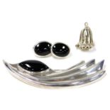 A silver and black onyx brooch, of comet form, together with a pair of silver and black onyx oval ea