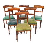 A set of six late Regency mahogany bar back single dining chairs, upholstered in green leatherette,