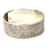 A 1950s silver bangle, on heavy floral design, with clip links, white metal stamped sterling silver,