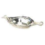 An Edward VII silver dish, in Art Nouveau style, of oval shaped form with pierced handles, embossed