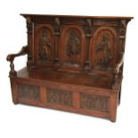 An oak settle in 17thC style, the carved back depicting three cavaliers, supported by four carved tu
