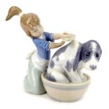 A Lladro figure group of young girl and puppy, in wash bath, 12cm high.
