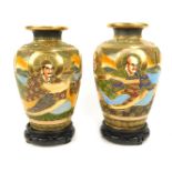 A pair of reproduction Japanese Satsuma vases, each relief decorated with warriors, with gilt and ra
