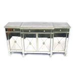 A 20thC mirrored breakfront sideboard, the top with a moulded edge, above one long and two adjacent