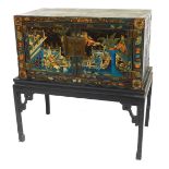 A 20thC Chinese lacquered cabinet on stand, the cabinet decorated with figures on horseback, in inte