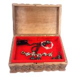 An Eastern hardwood jewellery box and contents, the outer case engraved with leaf and vine detail, w