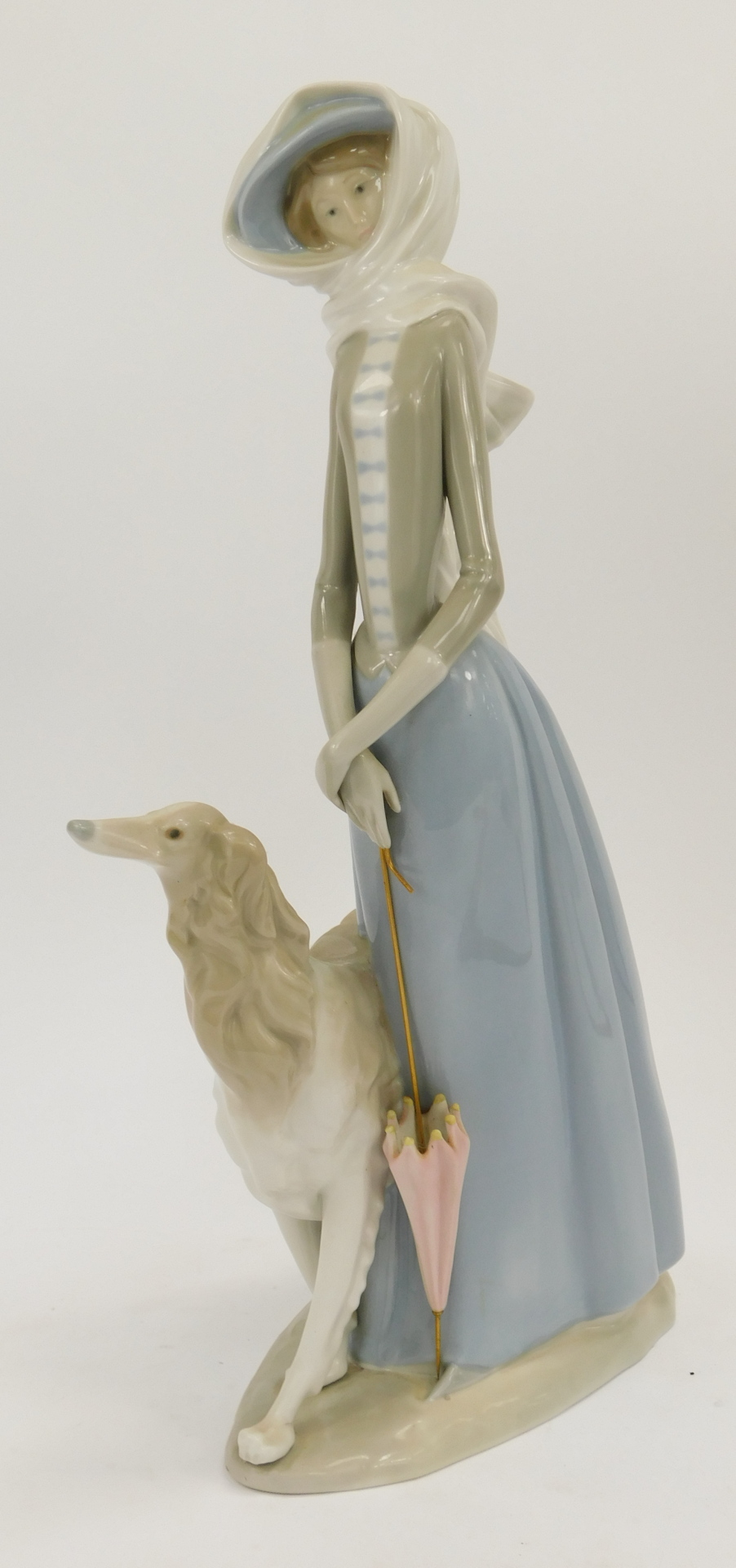 A Lladro figure group of a lady walking dog, with umbrella and wearing scarf, 39cm high, 22cm wide. - Image 2 of 4