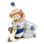 A Lladro figure of a clown and a dog, perched on wall, 11cm high.