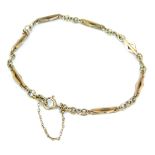 A small 9ct gold bracelet, the plain links interspersed with long lozenge shaped bar links, and with