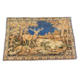 An Aubusson style tapestry wall hanging, depicting deer and flowers with a blue thread outer border,