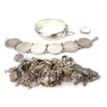 A collection of silver jewellery, comprising a silver charm bracelet with multiple charms, silver Ce
