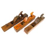 Two vintage wood block planes, one stamped Gedhg, one marked Keen Kutter, and an unmarked example. (