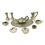 An Arts and Crafts pewter tea set, stamped Homeland, by W and Co, comprising teapot, coffee pot, mil