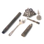 A group of silver trinkets, comprising a silver fountain pen case, cheroot holder, filigree butterfl