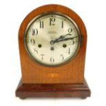 An early 20thC oak and inlaid mantel clock, the silvered Arabic numeral dial, named to W Greenwood,