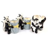 Three pottery Looney Tunes collectables, comprising two vases of Pepe Le Pew holding a bundle of fab