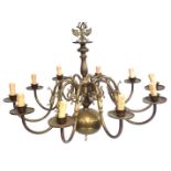 A ten branch brass Dutch style chandelier, the top surmounted by a double eagle motif, and turned co